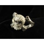 A 10 Carat White Gold Skull Ring studded with Diamonds on a millegrain setting.