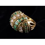 A Large 18 Carat Gold, Diamond and Emerald 'Turban' Ring set with wrythen bands of graduated stones.