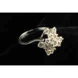 A Diamond & White Gold Dress Ring set with 13 brilliant cut stones totalling 1.