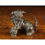 A Ming Bronze Kylin with front paw raised on a pierced ball, 4" (10 cm) high, 4½" (11 cm) in length.