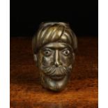 An Early 19th Century French Pressed Horn Snuff Box in the form of a Turk's head with glass inset