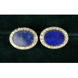 A Pair of Fine Diamond & Lapis Lazuli Cuff Studs; the flat oval lapis mounts bordered by diamonds.