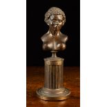 A 19th Century Bronze Bust of an African Female Nude mounted on a stop fluted columnar pedestal