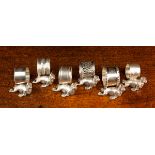 Six White Metal Napkin Rings of various designs, each mounted on the side of a seal.
