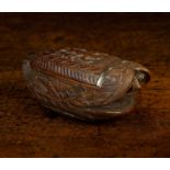 An Early 19th Century Coquilla Nut Snuff Box intricately carved with a winged cherub to the hinged