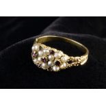 A Victorian Gold Ring set with a cluster of seed pearls and garnets,