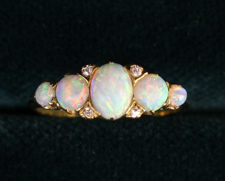 A Lady's 18 Carat Yellow Gold Ring set with five opals and four small diamonds flanking the central - Image 2 of 5