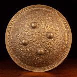 A 19th Century Indo-Persian Repoussé Brass Shield of round domed form.