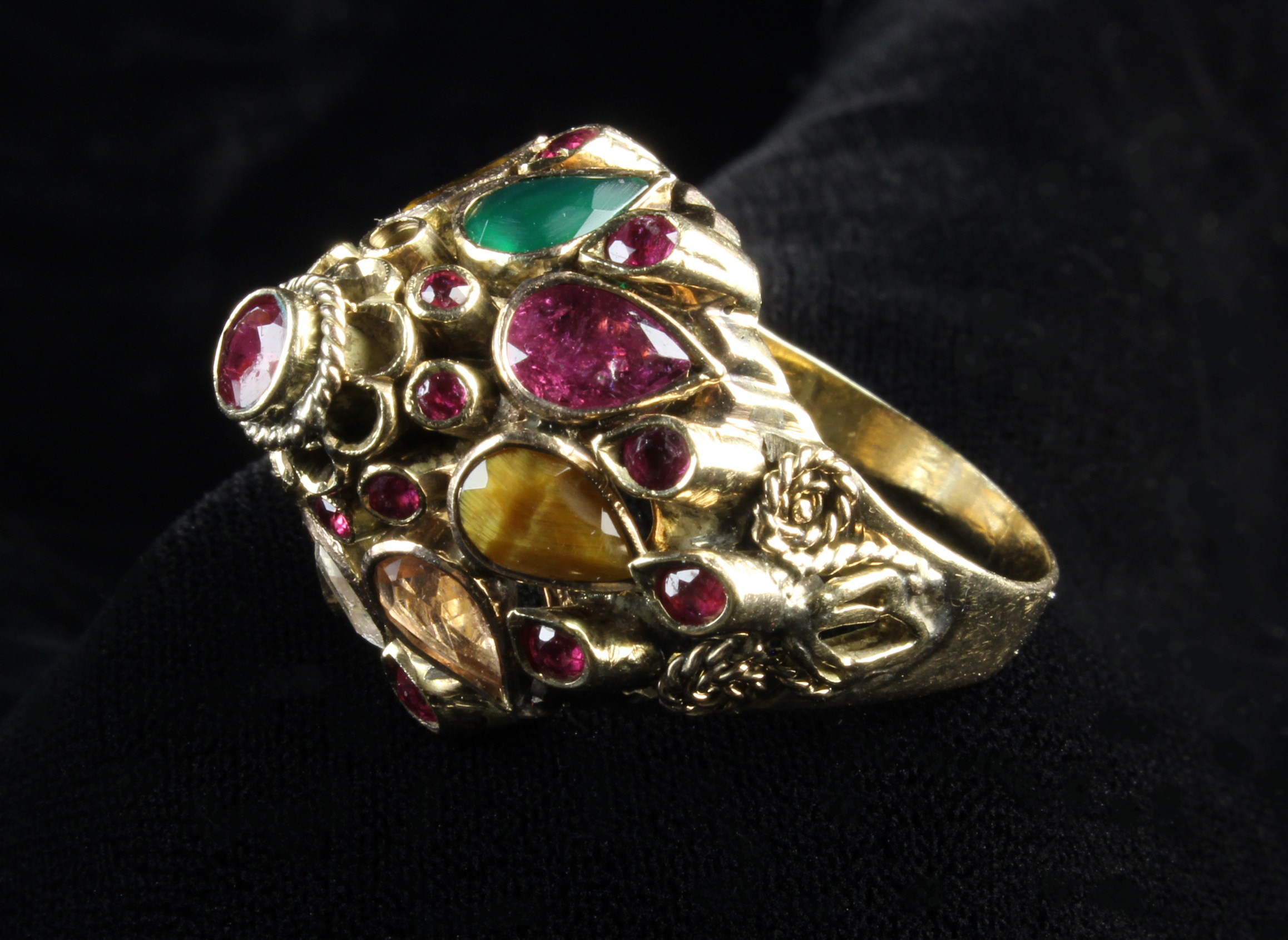 An 18th Carat Yellow Gold Marharja Ring set with Rubies, and teardrop petals of rubies, sapphire,