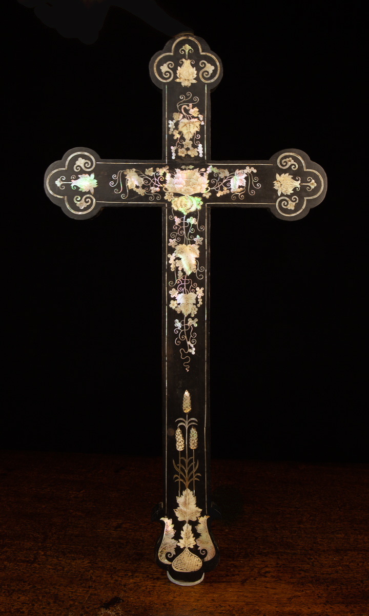 A 19th Century Ebony Crucifix intricately inlaid with mother-of pearl fruiting vines,