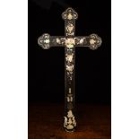 A 19th Century Ebony Crucifix intricately inlaid with mother-of pearl fruiting vines,