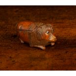 A 19th Century Treen Snuff Box naively carved in the form of a reclining dog with inset bead eyes