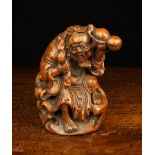 An Oriental Bamboo Carving of an elderly man carrying a fruiting peach bough over his shoulder,