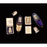 Six Collectable Silver Thimbles: One with cast ribbon swagged edge and an enamelled cap decorated