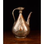 A 17th Century Safavid Copper Ewer of flattened teardrop form with residual tinning,
