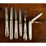 A Group of Five Silver Folding Fruit Knives with decoratively engraved handles and a Small Silver