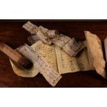 An Antique Islamic Scroll with script on vellum and paper fragments; the wooden holder 10" (25.