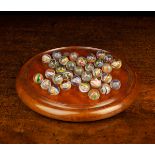 A Late 19th Century Turned Mahogany Solitaire Board with handblown glass marbles with coloured