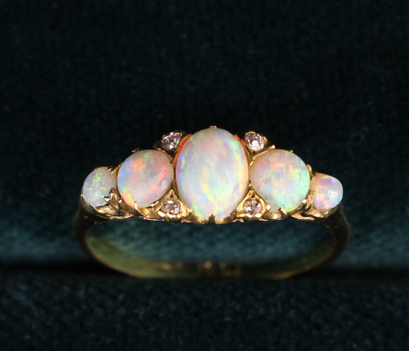 A Lady's 18 Carat Yellow Gold Ring set with five opals and four small diamonds flanking the central - Image 3 of 5