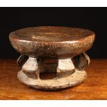 A 19th Century Tribal Cameroon Stool dug out and carved from a cross-section of tree trunk with a