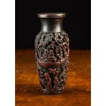 A Small Antique Chinese Dark Cinnabar Resin Baluster Vase profusely carved with figures and animals