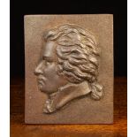 A 19th Century Cast Iron Plaque depicting a relief cast profile portrait bust, probably Mozart,