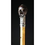 A Historical 19th Century Belgian Colonial Malacca Walking Stick with ebony handle carved in the