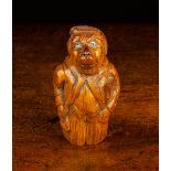 A 19th Century Treen Snuff Box carved in the form of a monkey man wearing morning dress with a
