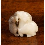 A Fine 19th Century Bi-colour Jade Carving of a Deer and Young, 1½" (4 cm) high.