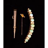 A 15 Carat Gold Tie Pin set with seed pearls and a ruby to a small gold flower head.