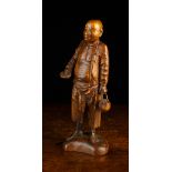 A 19th Century Eastern Wooden Carving of a Monk carrying a bowl and water kettle,