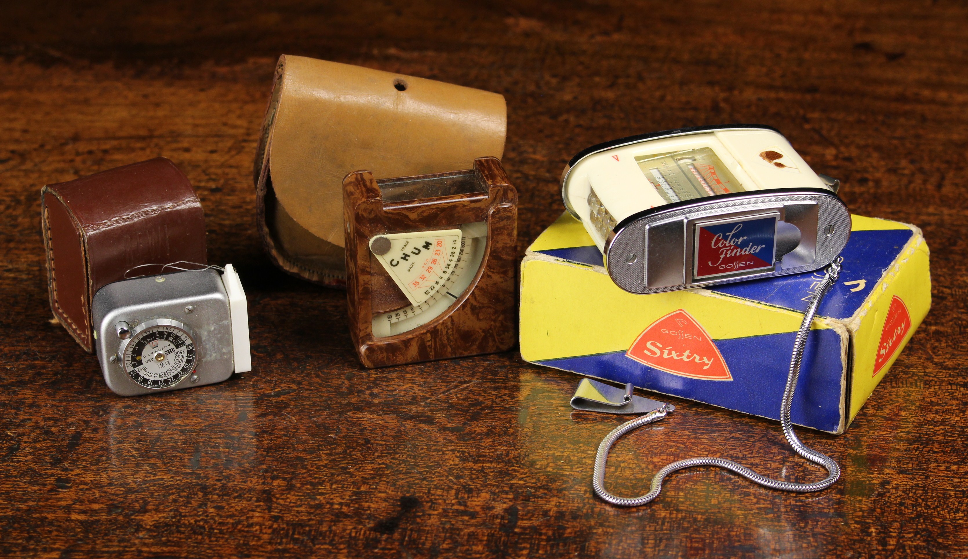 Three Vintage Light Meters; a bakelite Arthur G Gosling 'Chum' in a leather case,