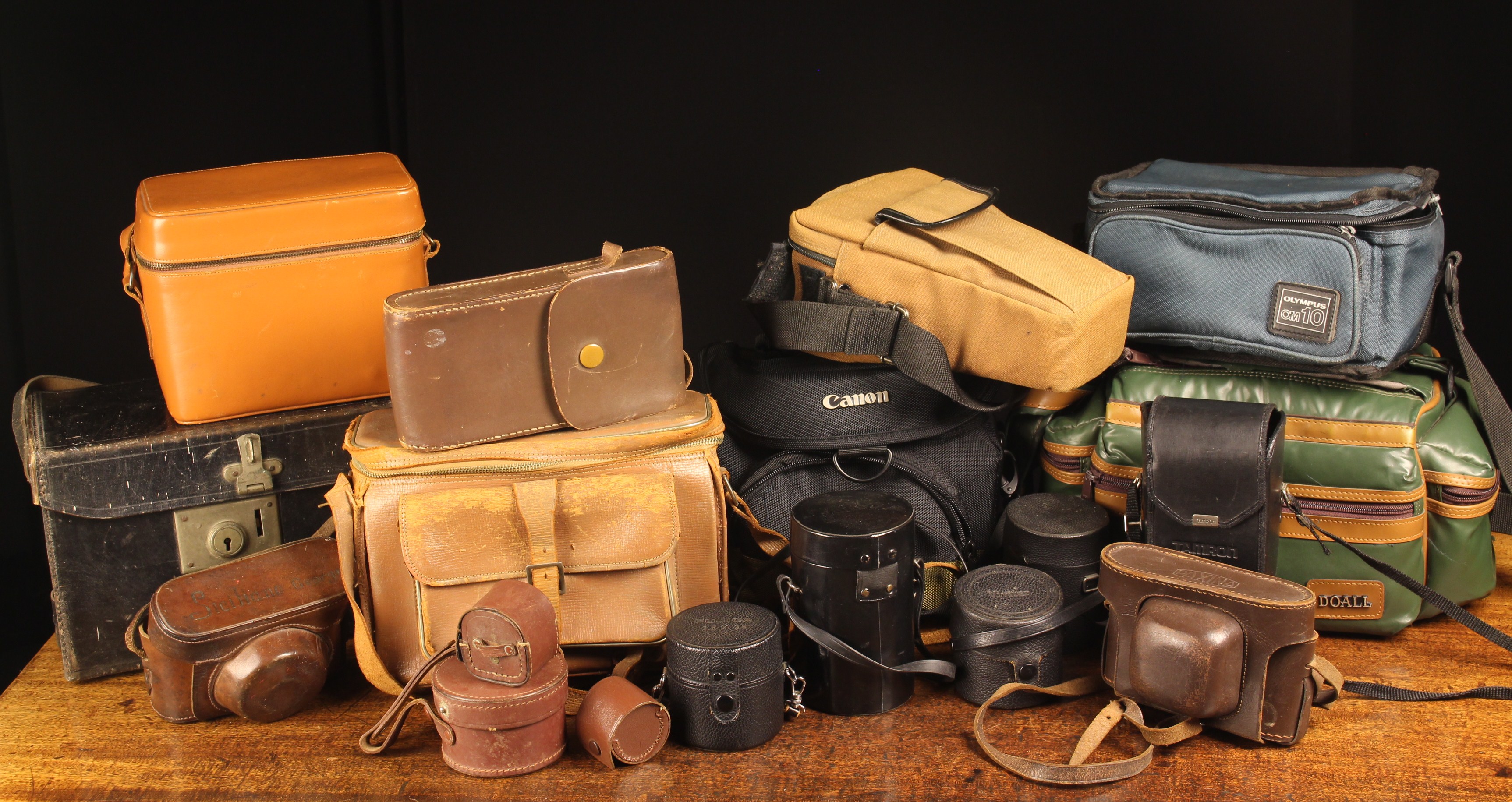 A Collection of Old and Used Camera Bags and straps.