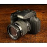 A Fujifilm HS 30 Digital Camera with 24-72 mm zoom lens, a Kenko 4 GB card,