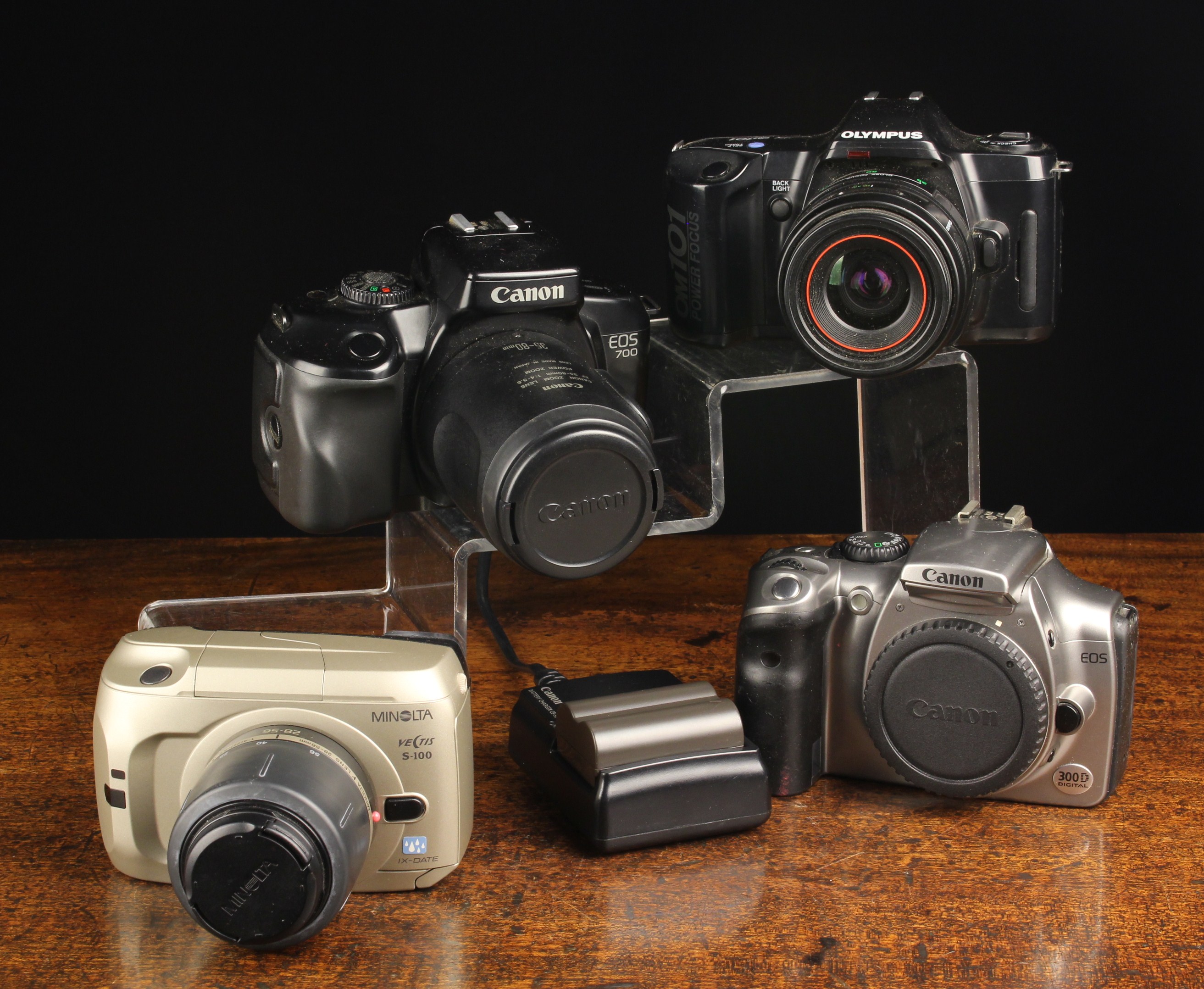 Four 1980'2 and 90's Film and Digital Cameras:- A Canon EOS 700 with 35-80mm power 200m lens.