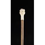 An Antique Walking Stick with a carved bone handle in the form of a cluster of twelve children's