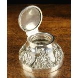 An Art Nouveau Silver Mounted Inkwell. The hinged circular lid engraved with a monogram.