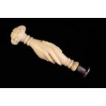 A Victorian Ivory Handled Seal carved in the form of clasped hands of friendship with lace cuffs
