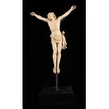 An Early 19th Century Ivory Corpus Christi carved in detail and mounted on a display stand,