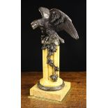 A Late 19th Century Bronze Eagle perched on a rock mounted atop a stop-fluted Sienna marble column