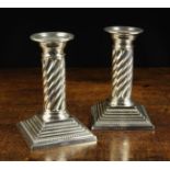A Pair of Mappin & Webb Silver Candlesticks having beaded bobeches slotting into wrythen fluted