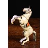 A Vintage Tin Plate Toy Prancing Horse with articulated head and front legs, 5½" (14 cm) in length.
