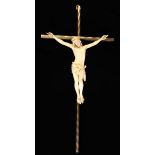 A 19th Century Carved Ivory Crucifix on a gilt brass cross, 9¾" (25 cm) in height.