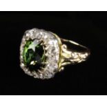 A Pretty Victorian Green Tourmaline and Diamond Ring. The oval cut tourmaline approx.