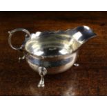 A George II Silver Sauce Boat by Benjamin Cartwright I, London 1745, having a serpentine rim,