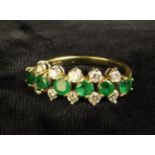 A Beautiful and Impressive Emerald and Diamond 18ct Gold Ring. The six, round cut, approx 0.