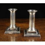 A Pair of Victorian Silver Clad Candlesticks with reeded column stems and beaded edges to the