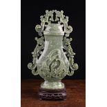 A Large Chinese Carved Jadeite Vase & Cover on a carved hardwood stand.