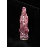 A Miniature Carved Ruby Stone Guanjin, 1" (2.5 cm) in height.