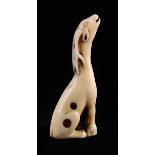 An 18th Century Kyoto School Ivory Netsuke carved in the form of a slender seated deer giving voice